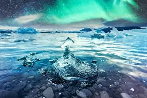 Aurora borealis northen light and icebergs in Jokulsarlon glacial lagoon. Vatnajokull National Park, southeast Iceland, Europe. Landscape photography