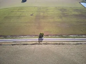 Grass And Sky Prints: Australia highway aerial view showing rural highway