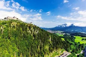At The Edge Of Prints: Austria, Tyrol, Reutte, Ruins of Ehrenberg Castle standing on top of forested hill in summer