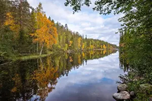 Autumn landscape with idyllic lake and fall colors at daytime in Hossa, National Park, Finland