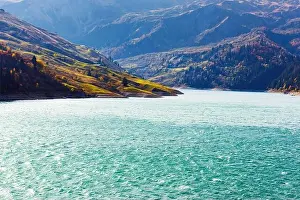 Beaufort Prints: Autumn picturesque view on Roselend lake (Lac de Roselend) in France Alps (Auvergne-Rhone-Alpes)