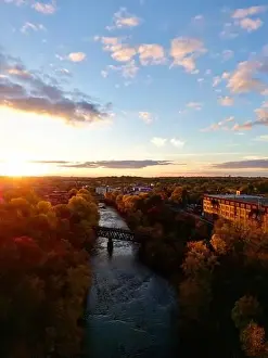 Golden Light Prints: Autumn sunset over winding Eau Claire river with historic railroad bridge
