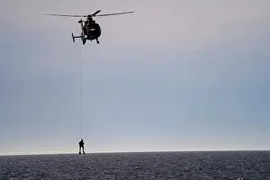 Attached Prints: The Aviation crew attached to the CAMPBELL deployed their rescue swimmer