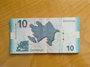 Bank Notes Prints: Azerbaijani currency, ten manat, isolated on a wooden table