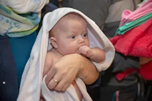Innocent Prints: Baby in church after baptism wrapped in towel