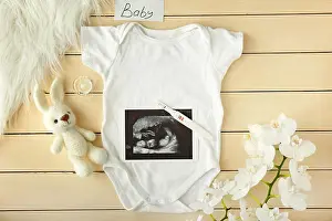Bodysuit Prints: Baby clothes, pregnancy test, toy and flowers on wooden background