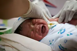 Refugee Prints: A baby cries through the process of immunization
