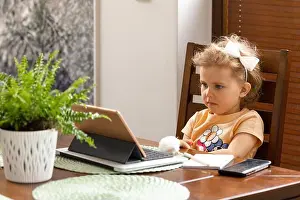 Digital Tablet Prints: Baby girl 3 years old with curly hair is sitting at table