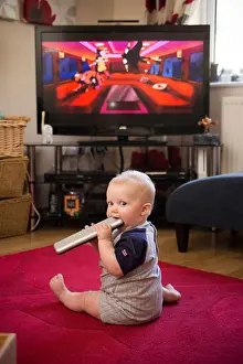 Calmness Prints: baby with remote control, tv remote