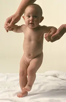 Supporting Prints: baby standing up with help of fathers support
