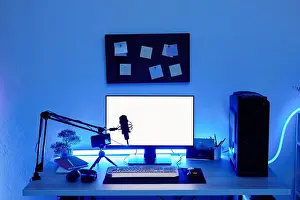 Gamer Prints: Background image of gaming setup PC on desk lit with blue neon lighting, screen mockup