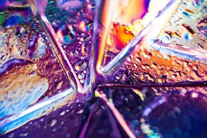 Background in the style of the 80-90s. Real texture of broken glass or ice and drops in bright acid colors