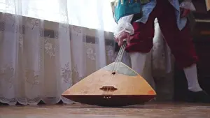 Folk Music Prints: Balalaika wooden in the hands of the musician