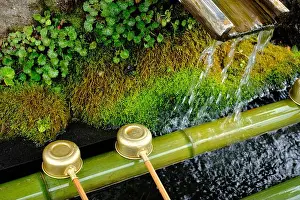 Cleansing Prints: Bamboo hishaku ladles at a temizuya for hand washing before entering a temple in Japan