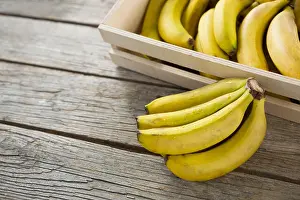 Temptation Prints: Bananas in wooden crate on wooden table