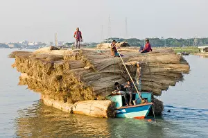 Bangladesh Prints: Bangladesh, South Asia, Boat heavily laden with a cargo of jute stems on river
