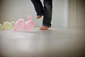 Barefooted Prints: Bare feet popping balloons inside a room