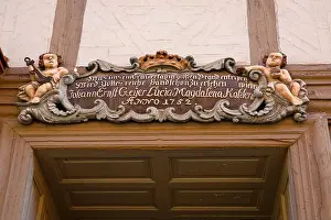 Woodwork Prints: Baroque cartouche with putti above old wooden door