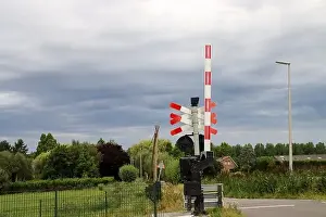Barriers and red lights at railroad crossing in Moordrecht in the Netherlands