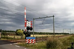 Delay Prints: Barriers and red lights at railroad crossing in Moordrecht in the Netherlands