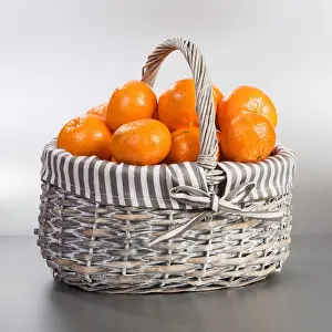 Wicker Prints: Basket with fresh tangerines on silver background