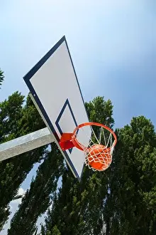 Outdoor Recreation Prints: A basketball landing in the net of a backboard