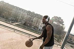 Flexibility Prints: Basketball player with headphones in action on court