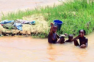 Madagascar Prints: Bathing in a muddy river in the Central Highlands in Madagascar