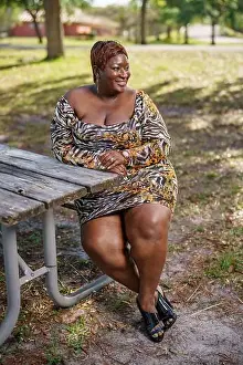 Forties Prints: BBW big black beautiful model sitting on a park bench outdoors