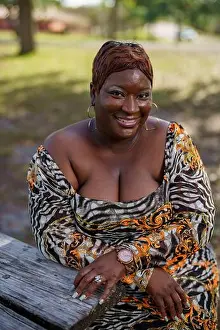 Forties Prints: BBW big black beautiful model sitting on a park bench outdoors