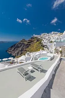 Beach bed chair with towel looking out over the caldera by the swimming pool, Santorini Oia. Luxury chaise lounge, amazing travel destination, summer
