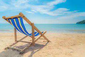 Swanage Prints: One beach chairs on the white sand with blue sky and summer sea background