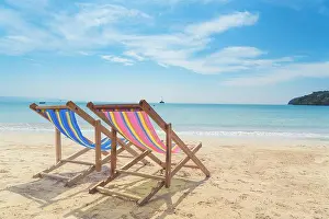 Two beach chairs on the white sand with blue sky and summer sea background. Summer, Vacation, Travel and Holiday concept