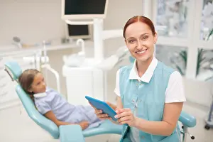 Dentistry Prints: Beaming beautiful child dentist smiling before examination