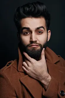 Pants Prints: bearded handsome man touching his beard and looking at the camera