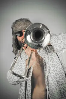 Pajamas Prints: Bearded hipster plays jazz trombone in leopard print bathrobe