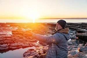 Remote Control Prints: Bearded man using a drone with remote controller making photos and videos