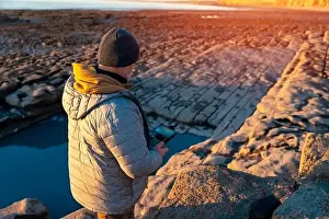 Remote Control Prints: Bearded man using a drone with remote controller making photos and videos