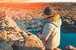 Remote Control Prints: Bearded man using a drone with remote controller making photos and videos