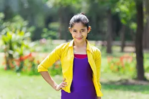 Weekend Activities Prints: Beautiful 1 Indian Young Girl Standing Hand-On-Hip In Park Smiling