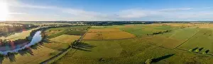Travel Locations Prints: Beautiful aerial panorama of green agricultural fields at sunset in Australia
