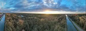 Green River Prints: Beautiful aerial panorama of a sunset over a river with green bushes and color rich sky