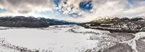 Beautiful Aerial Panoramic View of Canadian Mountain Landscape during a vibrant winter sunset