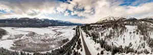 Beautiful Aerial Panoramic View of a road in Canadian Mountain Landscape during a vibrant winter sunset