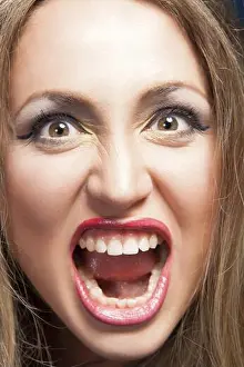 On White Prints: Beautiful agry blonde woman screaming, close-up photo