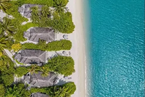 Beautiful atoll and island in Maldives from aerial view. Tranquil tropical landscape and seascape with palm trees on white sandy beach, amazing nature