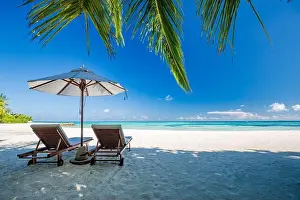 Beautiful beach landscape. Chairs on the sandy beach near the sea. Summer holiday and vacation concept for tourism. Inspirational tropical landscape