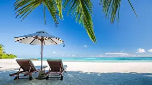 Beautiful beach landscape. Chairs on the sandy beach near the sea. Summer holiday and vacation concept for tourism. Inspirational tropical landscape