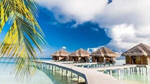 Images Dated 16th December 2015: Beautiful beach scene water bungalows. Summer holiday and vacation concept background
