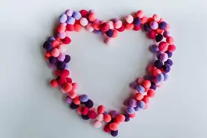 Dating Prints: A beautiful big heart made of soft pom-poms against a light background